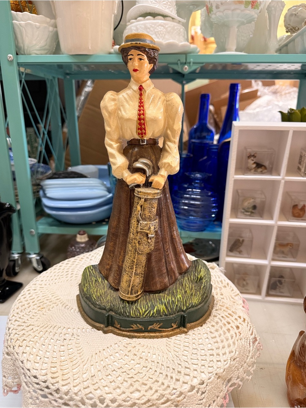 Vintage cast iron painted lady golfer doorstop with golf bag.